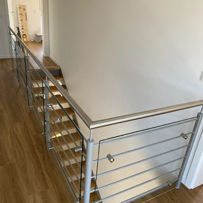 Modernes Treppengeländer mit Metallhandlaufelementen und Stufen