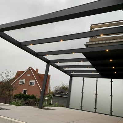Überdachte Terrasse mit Leuchten unter grauem Himmel